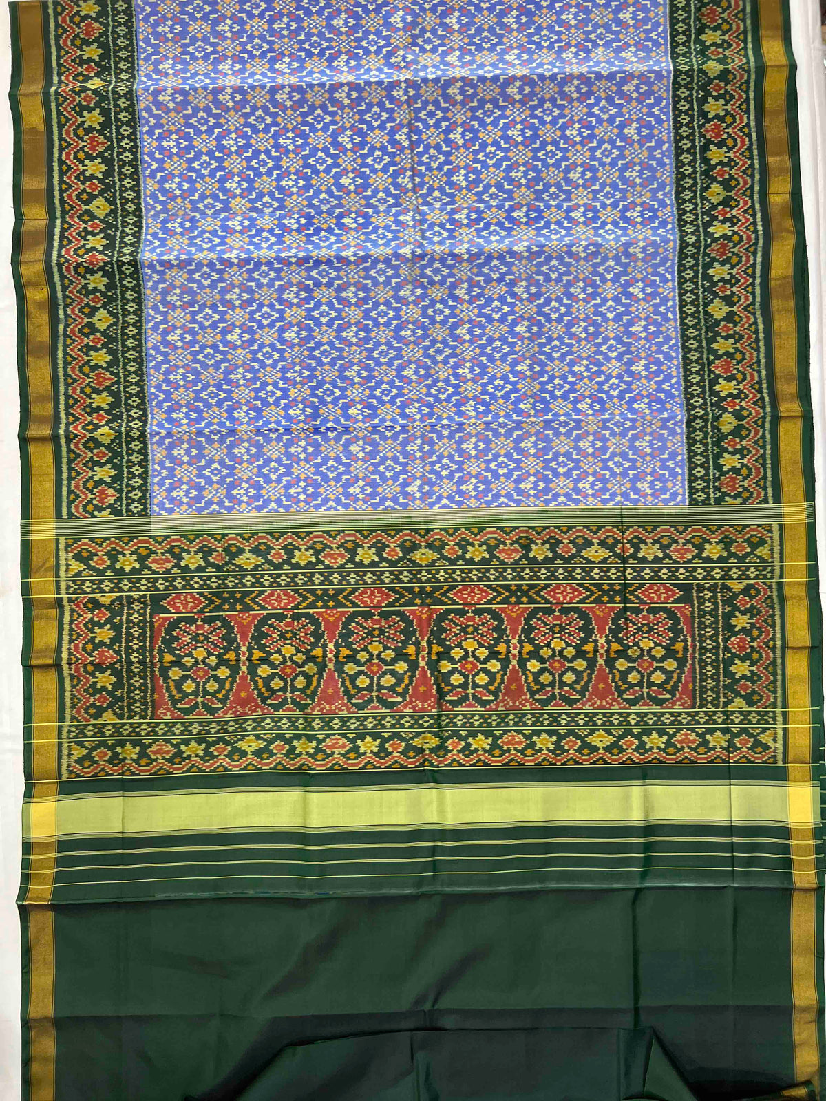 Beautiful sky blue batton-full desing with green bordar Pallu Patola sarees
