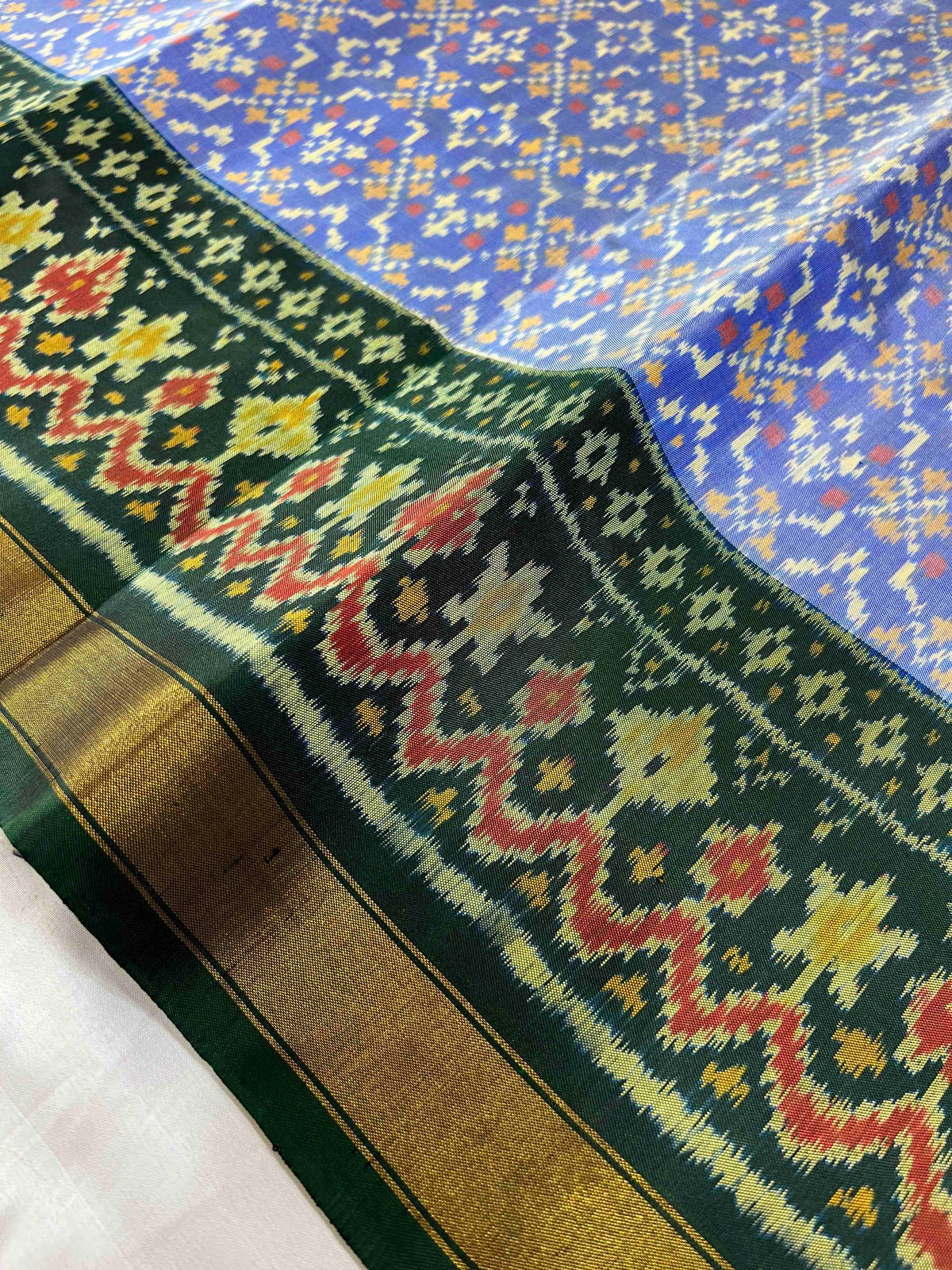 Beautiful sky blue batton-full desing with green bordar Pallu Patola sarees