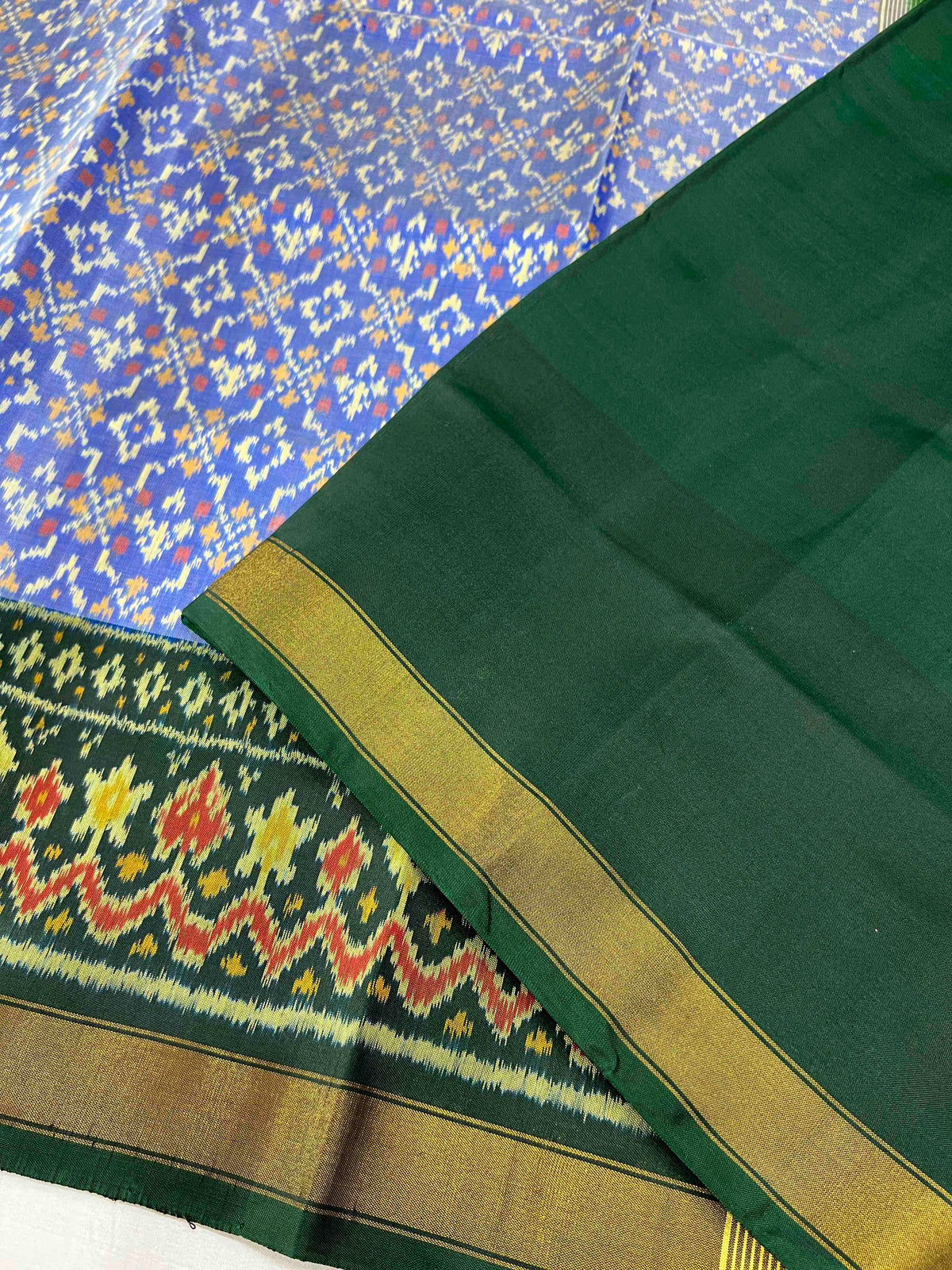 Beautiful sky blue batton-full desing with green bordar Pallu Patola sarees
