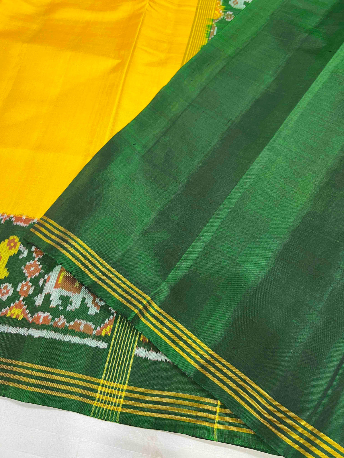 Beautiful plain yellow gala design with green bordar Pallu premium patola silk saree